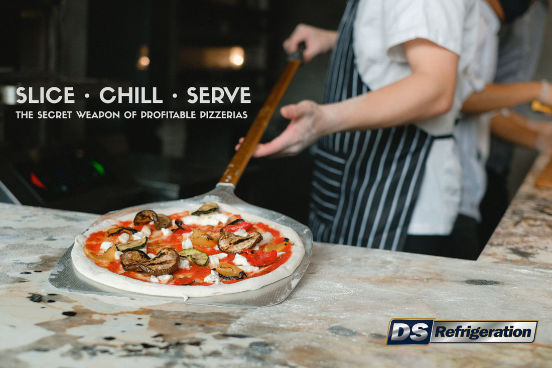 Commercial refrigerated pizza prep counter with fresh pizza toppings in a busy pizzeria kitchen.